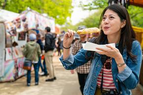Woman eating festival food at summer event