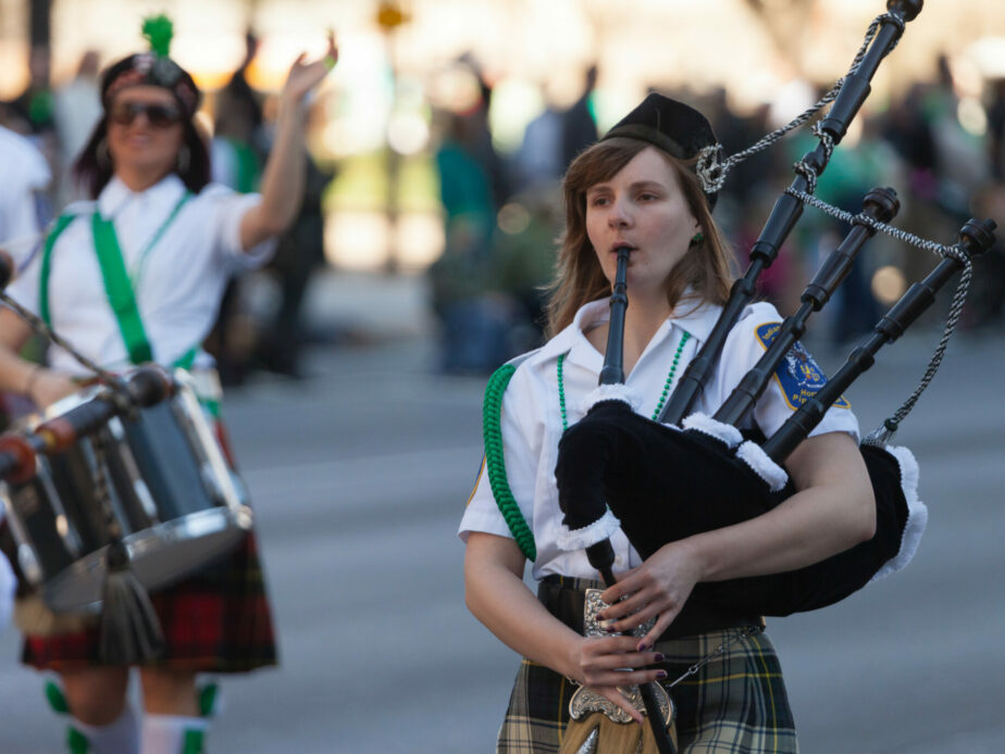 Woman plays traditional irish instrument in Saint Patrick's Day parade